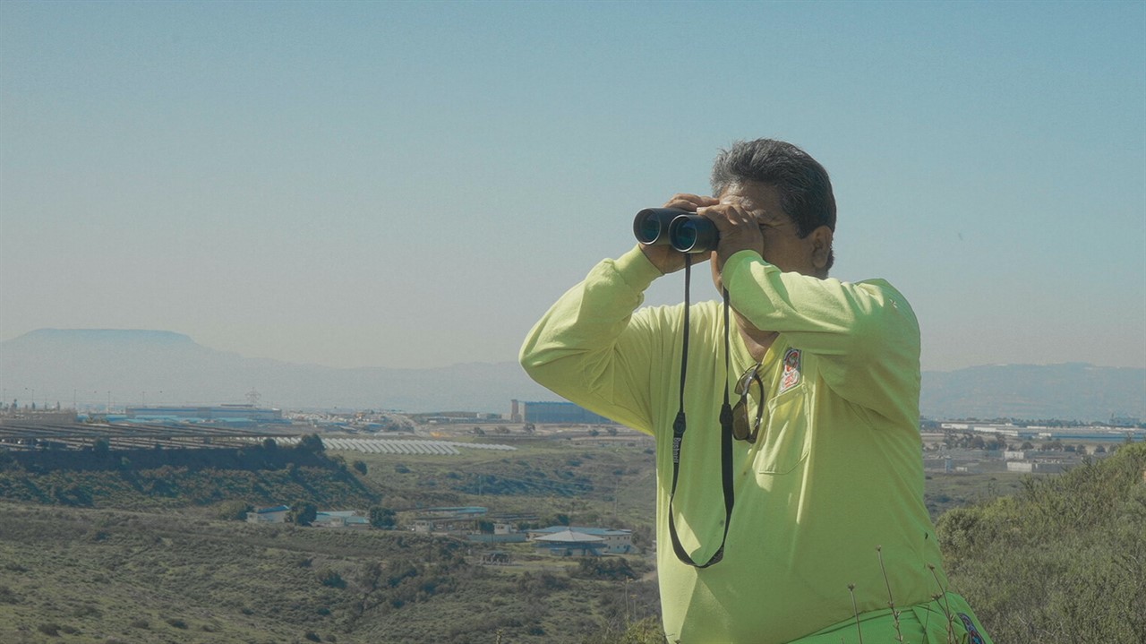 Man looking through binoculars